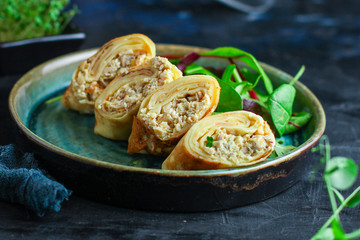 thin pancakes chicken filling fritter 
Menu concept healthy eating. food background top view copy space for text
table setting