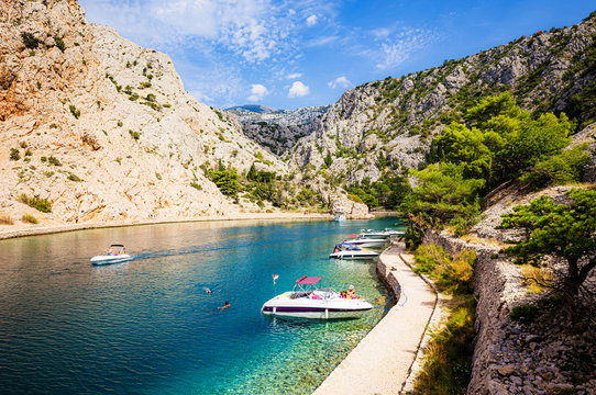 Scenic summer vacation scenery with tourists relaxing and swimming, Croatia