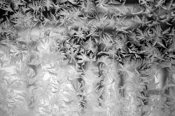 Winter texture of frost on the glass window as a background