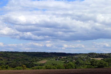 A village of several houses on a green hill