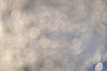 Abstract background of soft creamy bokeh circles.