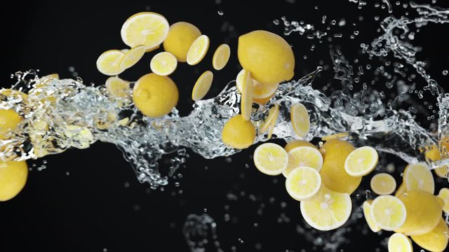 Abstract 3D animation of flying sliced lemons with crystal water. Render footage with fresh nice fruits and pouring splashing liquid on dark background with alpha matte chanel. 4k.