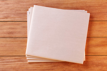 Top View of a Blank Newspaper on Wooden Desk or Table. Reading the News. Pen, Pencil, a Blank Notebook. Cup of coffe. Calculator. Copy space for text or Image.