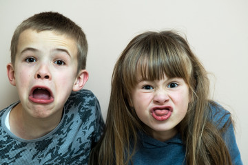 Two children boy and girl fooling around having fun together. Happy childhood concept.