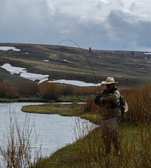 Fototapeta na wymiar A single man fly fishing in the high country of Wyoming.