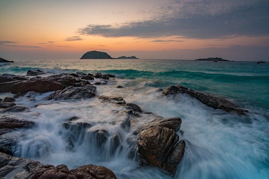 Waves crashing on coastal rocks at sunrise, Redang Island, Terengganu, Malaysia