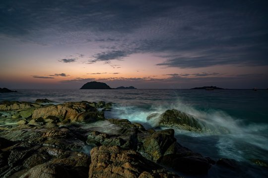 Waves crashing on coastal rocks at sunrise, Redang Island, Terengganu, Malaysia