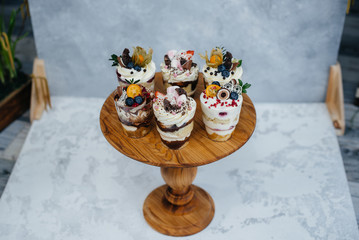 Set of beautiful delicious trifl close - up on the background. Dessert and sweets