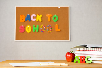 school desk with books, apple and INSCRIPTION OF the ABC, back to school, no one