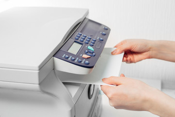 Hand press button on panel of printer. printer scanner laser office copy machine supplies start