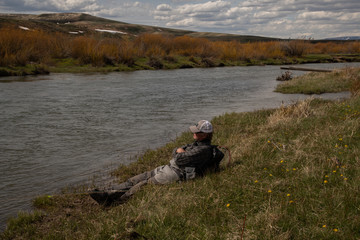 A mature male taking a stream side nap during a fly fishing outing.