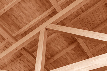 The construction of the wooden roof. Detailed photo of a wooden roof overlap construction.