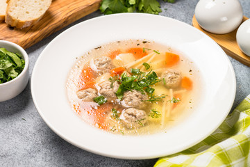 Meatballs soup with vegetables top view.