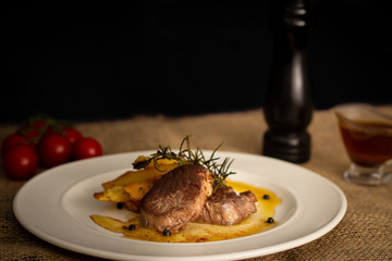 dish with fried potato, filett, tomatoes and beer
