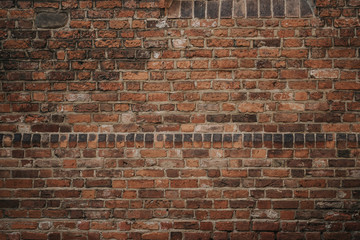 Background texture dark old red brick wall closeup. A grungy brick wall of an old building....