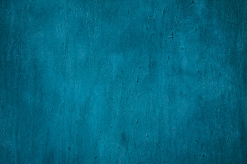 The textured wall is painted with blue paint. Background.	
