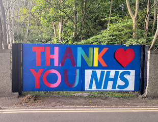Aberdeen, Scotland/UK - May 21, 2020: Big sign painted on a fence with the text "Thank you NHS" made in appreciation of the hard work done by NHS workers during COVID-19 in Scotland.