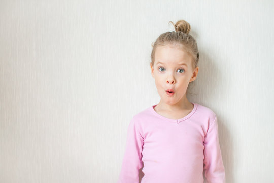 Little cute girl depicts emotions. Surprise