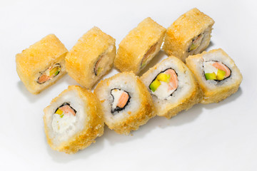 Japanese roll of rice, cream cheese, avocado and salmon on a white background