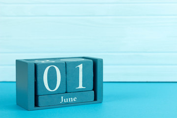 wooden calendar with the date of June 1 on a wooden background, World Milk Day, International Neighborhood Day, International Day of Doubt, World Parents Day, International Children's Day