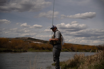 A man flying fishing on a wild trout stream in Wyoming.