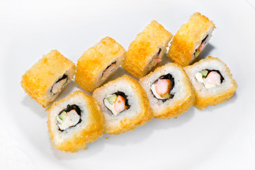 Japanese roll according to a traditional recipe of rice, shrimp, cream cheese and cucumber on a white background