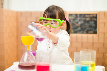 toddler girl pretend play scientist role for homeschooling