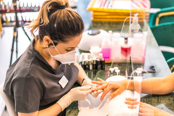 Manicure and pedicure beauty salon with security measures. Reopening after the corod-19 pandemic. Coronavirus