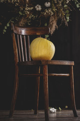 Pumpkin on a chair with decoration on background