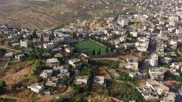 Aerial View over Palestinian Town Biddu with soccer field, Near Jerusalem 