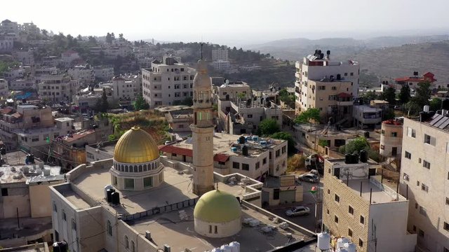 Aerial View over Golden Dome Mosque with hamas green flag in Palestine Town Biddu,Near Jerusalem