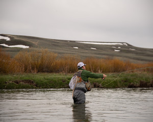 A man fly fishing on a western trout stream.