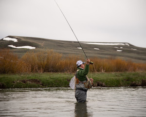 A man fly fishing on a western trout stream.