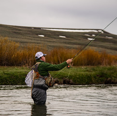 A man fly fishing on a western trout stream.