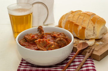 tasty and tradicional brazilian snack bar: gizzard, bread and cold beer.