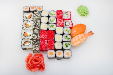 Classic big set of japanese rolls of takuan, salmon, cucumber, shrimp, sushi with salmon on a white background