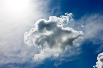 Fluffy clouds reaching up to heaven. Cumulus clouds in bright sunshine on a sunny day