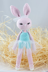 Amigurumi. Crochet rabbit handmade yarn soft toy baby present ballet pink  - obrazy, fototapety, plakaty