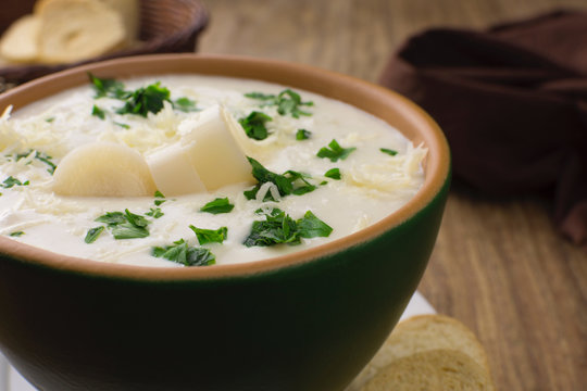 Palm heart soup close in wood background