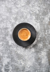 Cup of coffee on rustic wooden background. Top view. Copy space.