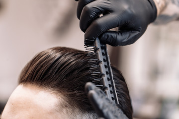 Men's haircut in a barbershop. Styling and hair care. 