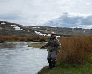 A man fly fishing on a wild western river.