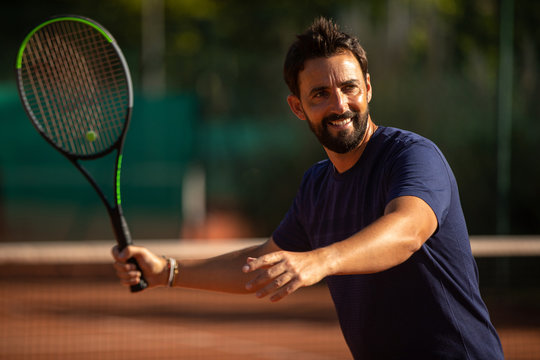 tennis player smiling and playing tennis