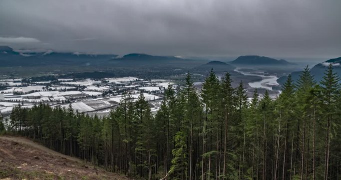 Overcast winter time lapse of Agassiz B.C., Canada and the Fraser river. View from the Mountains. Includes 2 versions - one stationary and one with a pan using the full resolution of the image.