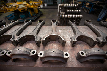 Obraz na płótnie Canvas Dismantled locomotive driver. Engine parts lie on a table in a factory