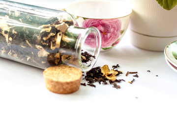 Obraz na płótnie Canvas Cup of tea. Large tea leaves in a Cup. A can of tea. Large-leaf tea with fruit. 