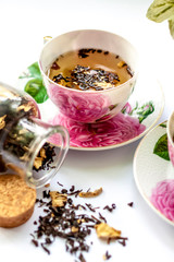 Cup of tea. Large tea leaves in a Cup. A can of tea. Large-leaf tea with fruit. 