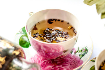 Cup of tea. Large tea leaves in a Cup. Large-leaf tea with fruit. Tea party.