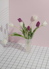 Bouquet of colored tulips on a checkered pink background. Concept template nature blog, social media, flowers concept. Conceptual art minimalistic photography. Copy space