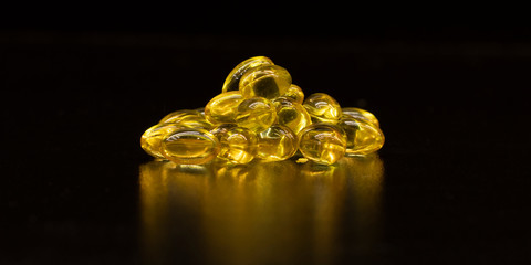 Beautiful yellow transparent pills closeup. Medical concept